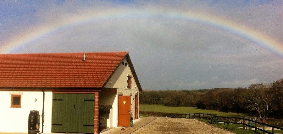 The facilities block at Appledore Park beneath a rainbow